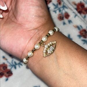 Elegant Gold and Pearl Bracelet with Eye Charm